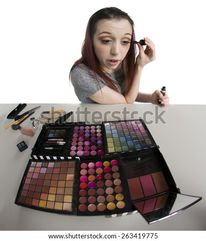 Young Teenage Woman with Large Palette of Make Up Applying Mascara to Eyelashes, Fish Eye View
