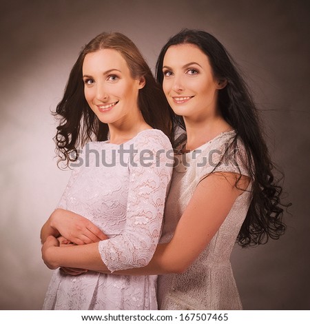 Two sisters smiling and hugging