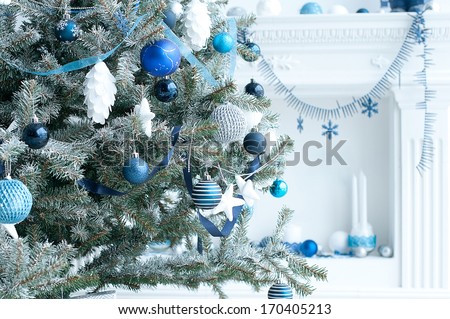 Christmas tree with blue and white toys in the interior / Christmas card with white and blue decor