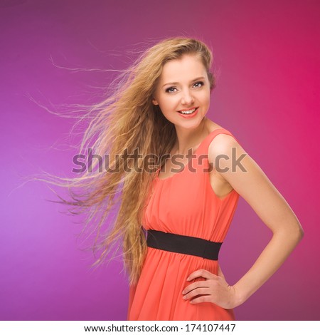 Girl with long hair on rainbow background. Wind in your hair. Blonde.