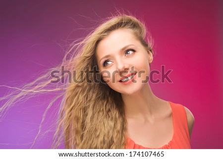 Girl with long hair on rainbow background. Wind in your hair. Blonde.