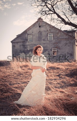 Girl in white dress. Bride in the park. Photo in vintage style. Mystery.