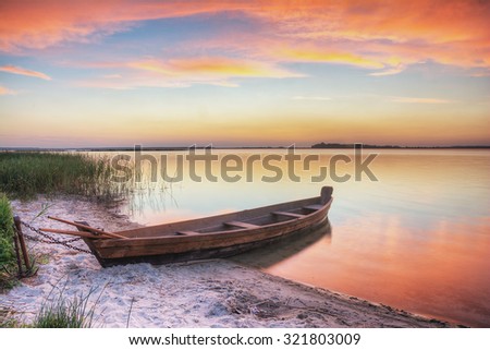 Twilight on the lake, fishing boats on the shore