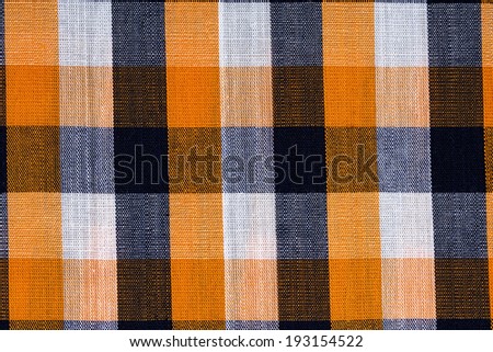 Fabric into orange grid, a background or texture