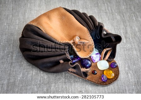 leather purse with semi-precious stones on linen cloth