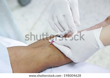 asian nurse inject at patient\'s arm for intravenous fluid