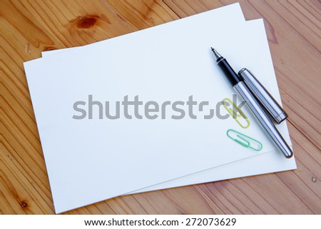 blank white notebook  and  pen  on the desk