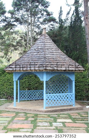 Blue wooden pavilion in the garden.