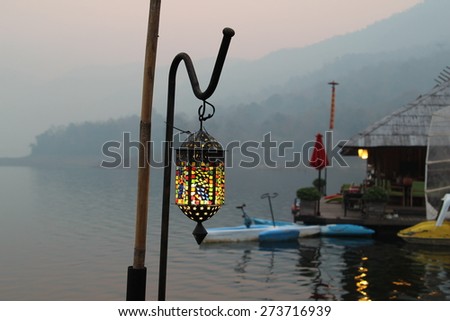 Antique lamp standing on floating resort.