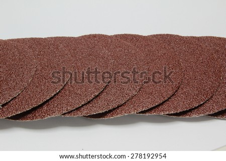 Disk of brown sandpaper isolated on white background.