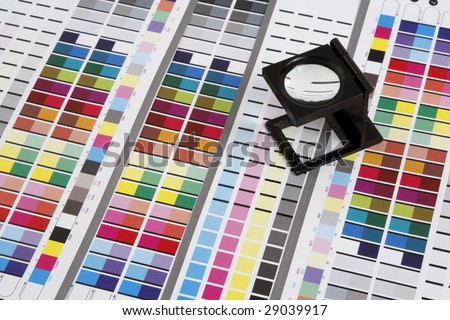 Prepress color management in print production. CMYK color check on printed paper. Quality printing concept