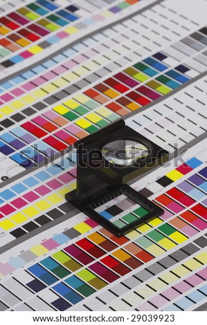 Prepress color management in print production. CMYK color check on printed paper. Quality printing concept