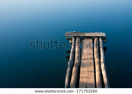 Footbridge over the smooth water.