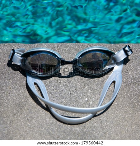 Swimming sport goggles on the poolside
