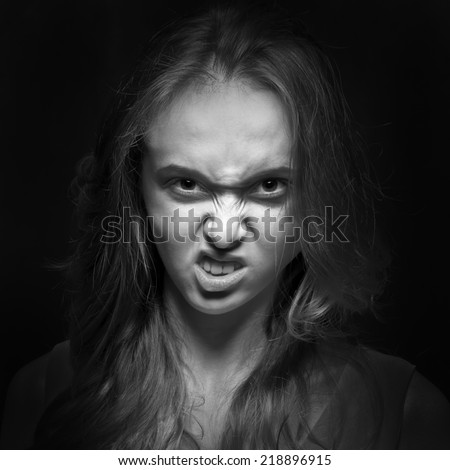 Scary girl looking and showing teeth