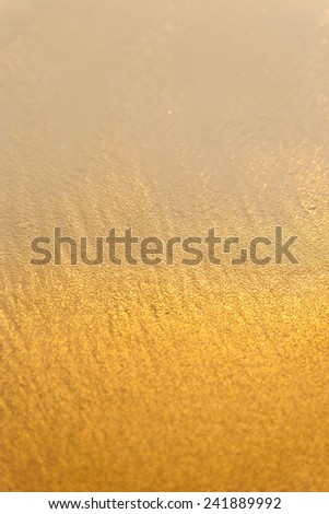 Background of gold sand and wave.