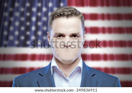 Symbol of censorship and freedom of speech: a young man without a mouth on a background of the national flag of USA (America)