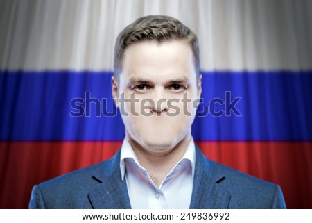 Symbol of censorship and freedom of speech: a young man without a mouth on a background of the national flag of Russia