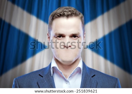 Symbol of censorship and freedom of speech: a young man without a mouth on a background of the national flag of Scotland