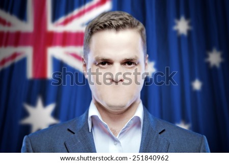 Symbol of censorship and freedom of speech: a young man without a mouth on a background of the national flag of Australia