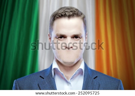 Symbol of censorship and freedom of speech: a young man without a mouth on a background of the national flag of Ireland