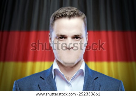 Symbol of censorship and freedom of speech: a young man without a mouth on a background of the national flag of Germany