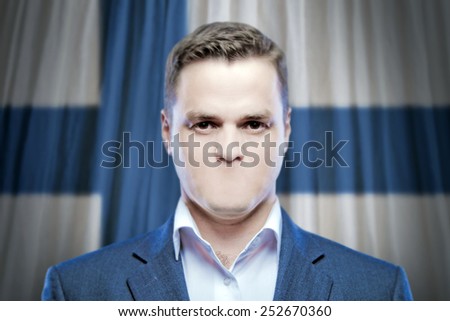 Symbol of censorship and freedom of speech: a young man without a mouth on a background of the national flag of Finland