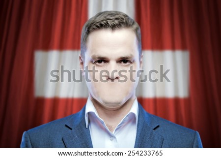 Symbol of censorship and freedom of speech: a young man without a mouth on a background of the national flag of Swiss