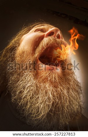 Unusual portrait of a bearded man with fire