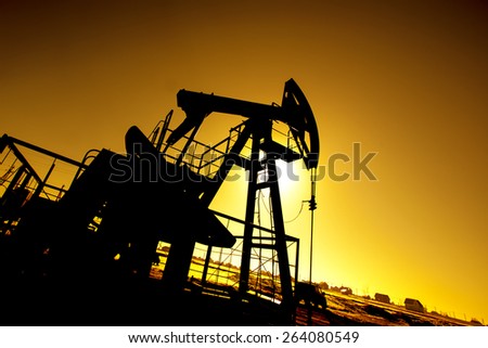 Oil pump on background of red (orange) sky