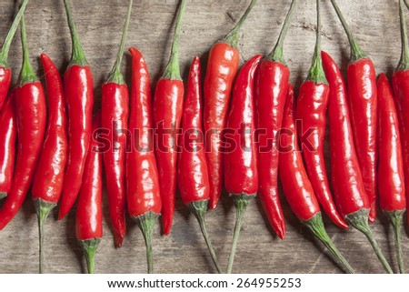 The composition of red hot peppers on a wooden table