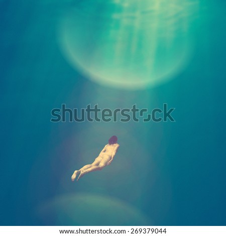 Fantasy naked female diver deep under water - instagram style