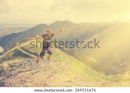 Man jumps up on a background of mountains - instagram style