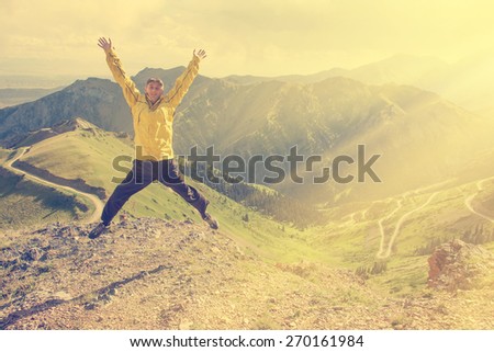 Man jumps up on a background of mountains
