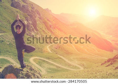 Woman doing yoga in the mountains