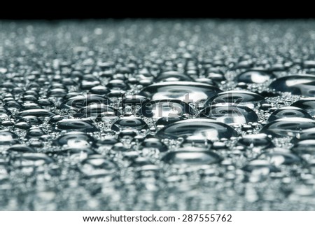 Water droplets on green metal - a beautiful unusual texture