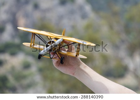 Toy airplane in hand - a symbol of travel and dreams