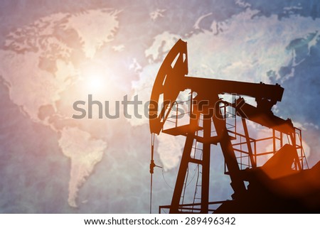 Oil pump on background of world map