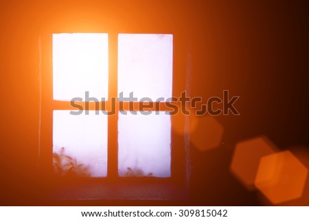 A ray of morning sun in an old window