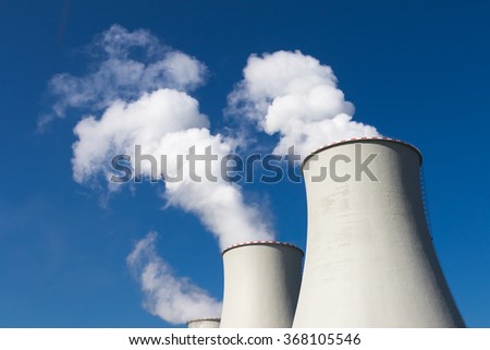 Industrial exhaust pipe with inscription against the sky and smoke