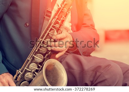 Saxophone in the hands of a street musician