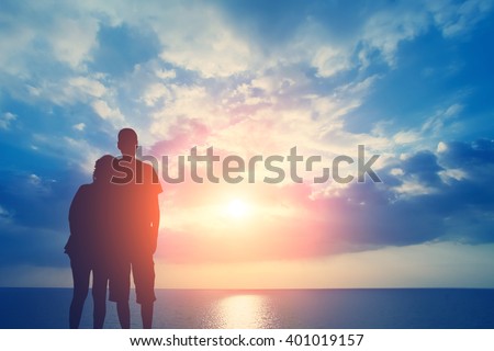 Couple in love on the background of the sea and sky with clouds