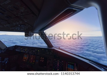 Sky view from airplane inside cockpit when airplane fly over the cloud. Seen in evening twilight.
