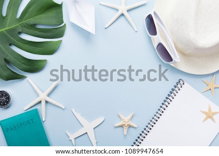 Summer holidays, vacation, travel and tourism background from sunglasses, hat, passport, notepad, palm leaf, airplane and ship. Top view. Flat lay.
