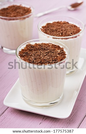 Milkshake with chocolate on a pink surface