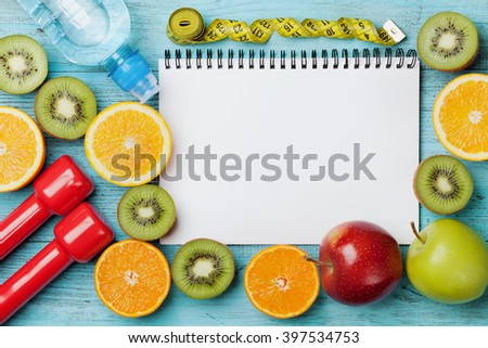 Diet plan, menu or program, tape measure, water, dumbbells and diet food of fresh fruits on blue background, weight loss and detox concept, top view
