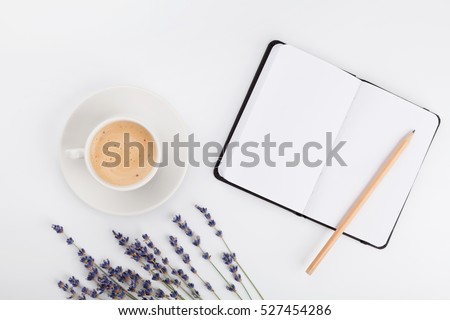 Coffee, clean notebook and lavender flower on white table from above. Woman working desk. Cozy breakfast. Mockup. Flat lay style