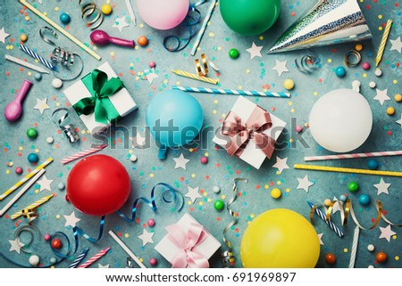 Birthday party background with colorful balloon, gift, confetti, cap, star, candy and streamer. Flat lay style. Festive greeting card.