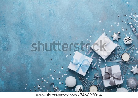 Fashion christmas background. Gift boxes and holiday decoration on blue vintage table top view. Flat lay. Greeting card with copy space for text.