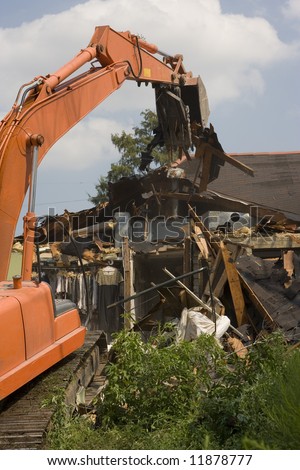 A flood damaged home in the Lakeview section of New Orleans is demolished